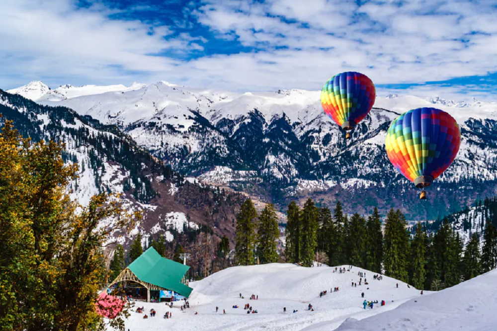 Colorful hot air balloons soaring over snowy mountains and lush pine trees, creating a stunning contrast against the clear blue sky.